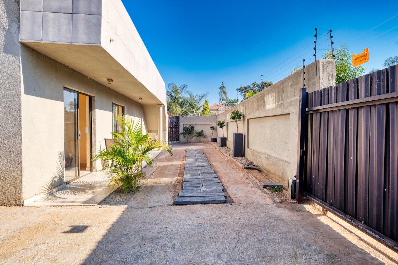 A courtyard with a gate and a fence